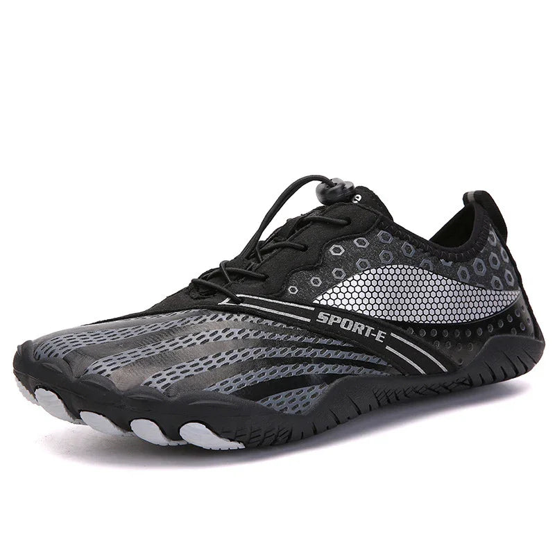 Black and gray sporty minimalist athletic shoe with hexagonal patterns and quick lace system