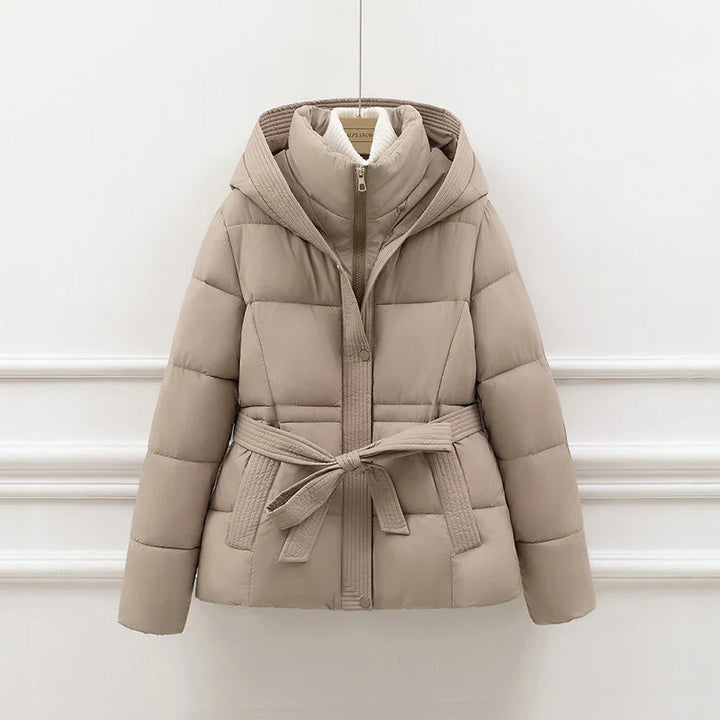 Beige padded winter jacket with hood, belt tie waist, and front zipper on white background