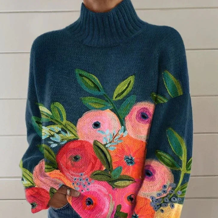 Cozy dark blue turtleneck sweater with vibrant pink and red floral and green leaf patterns