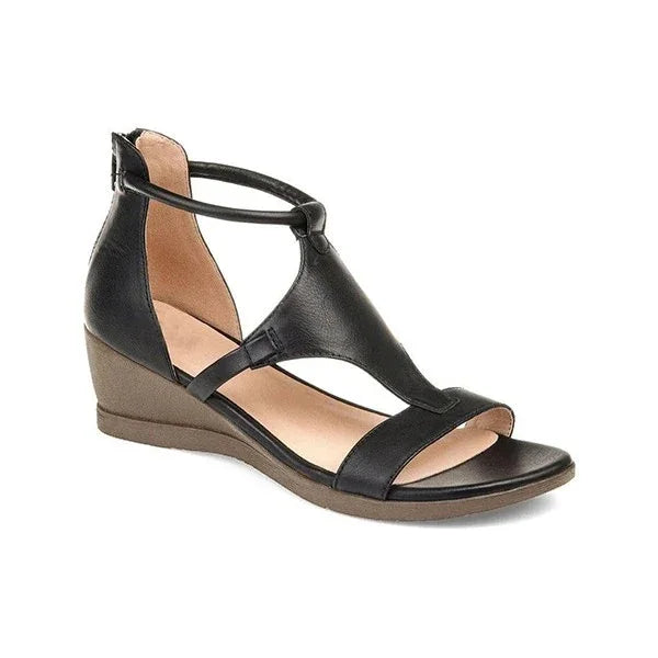 Black leather wedge sandal with T-strap and open toe design on white background