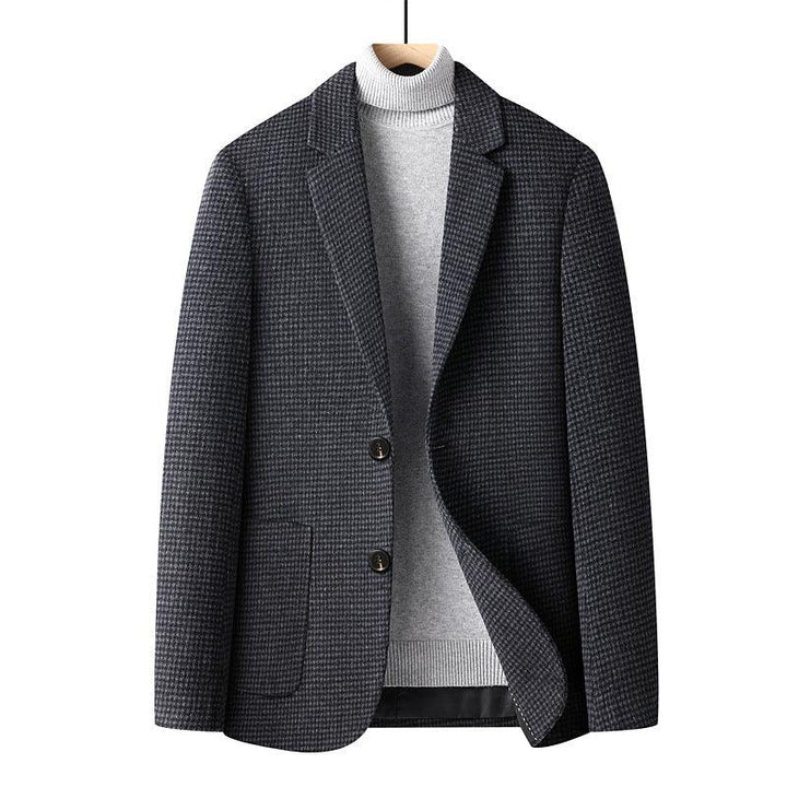 dark gray houndstooth blazer paired with light gray turtleneck sweater on wooden hanger