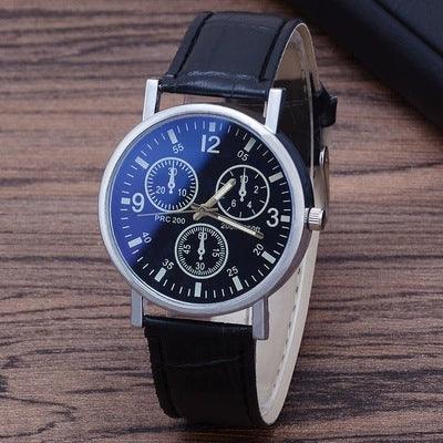 Black leather strap wristwatch with silver case and multiple dial chronograph on wooden surface
