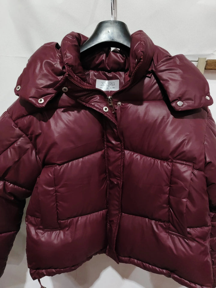 Maroon puffer jacket with high collar and snap buttons on hanger