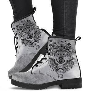 grey suede lace-up boots with black soles featuring detailed wolf and dreamcatcher designs, worn with black pants