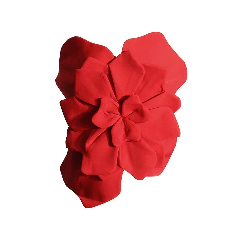 Large red fabric flower with multiple layered petals on white background
