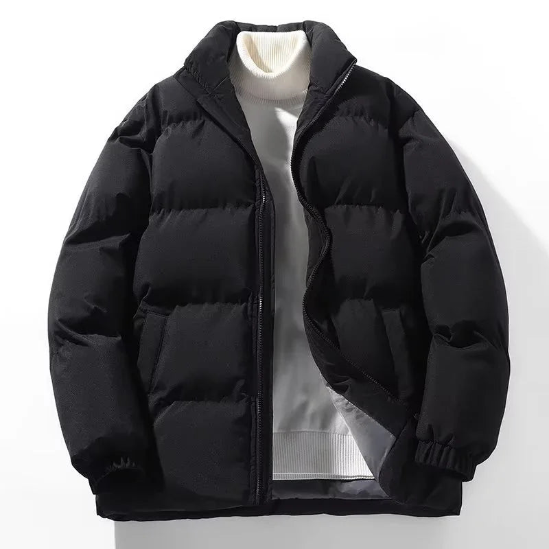 black puffer jacket layered over white turtleneck sweater on white background