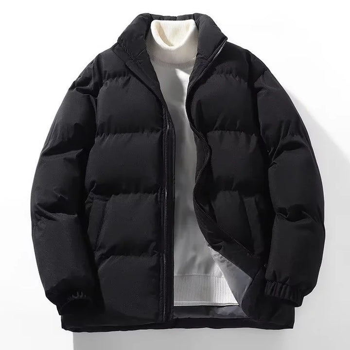 black puffer jacket layered over white turtleneck sweater on white background