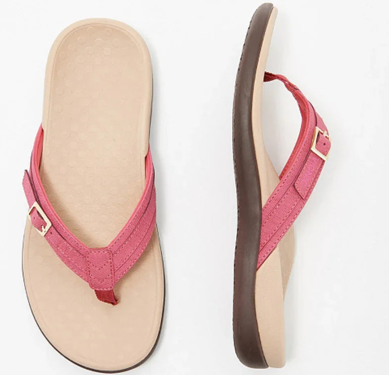 Pink fabric strap flip flop sandals with beige footbed and brown sole, casual summer footwear