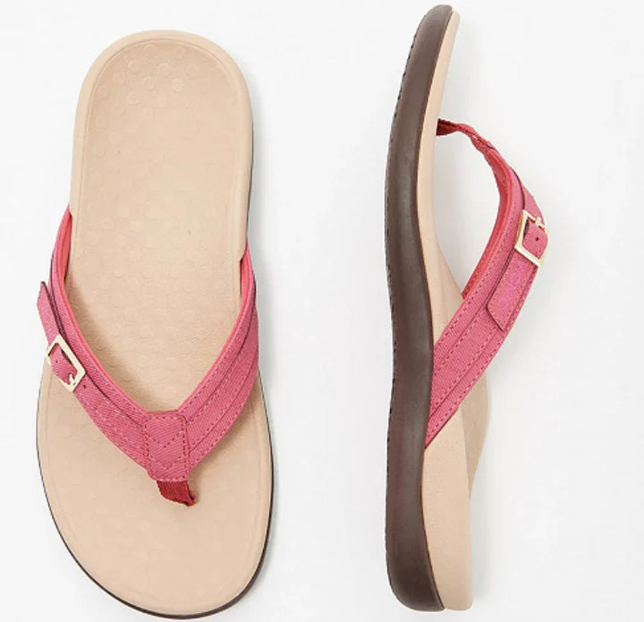 Pink fabric strap flip flop sandals with beige footbed and brown sole, casual summer footwear