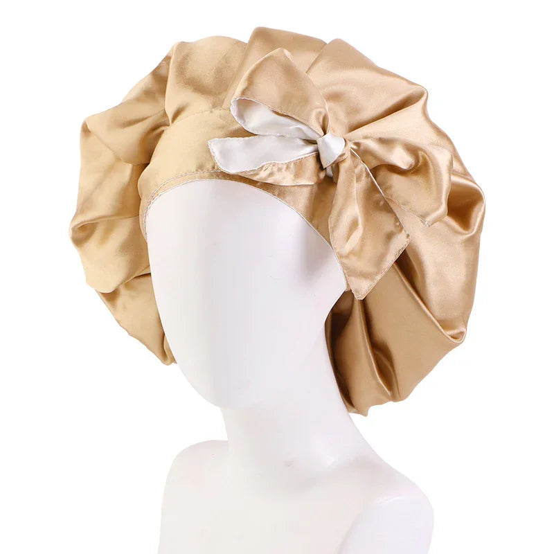 Beige satin bonnet with a large bow on a white mannequin head