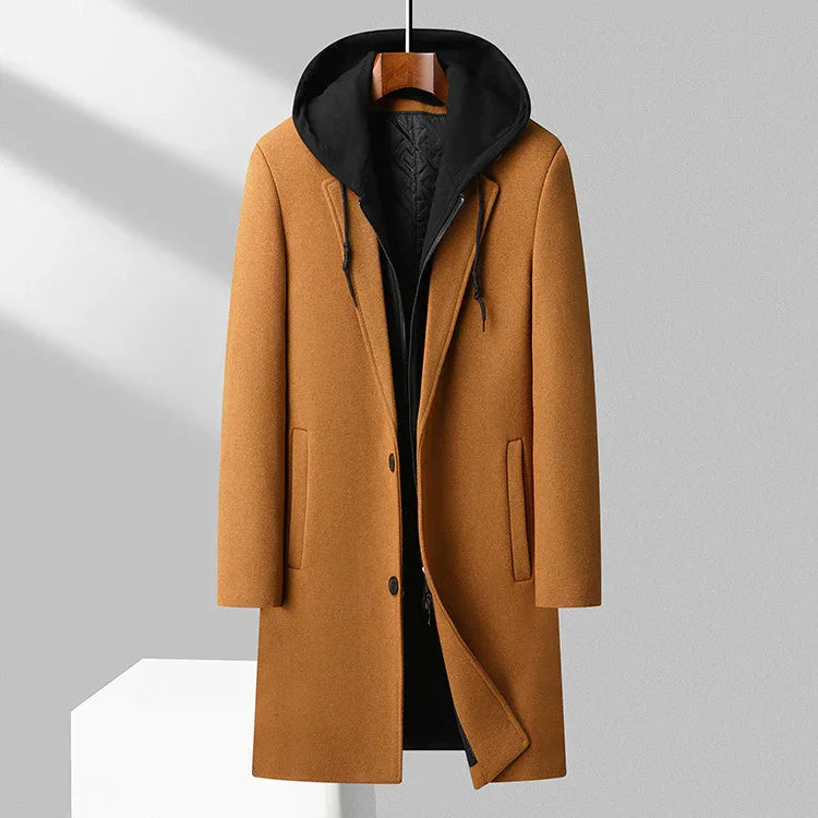 Stylish camel brown wool coat with black hooded inner layer hanging on wooden hanger