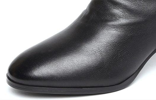 Close-up of a sleek black leather pointed-toe dress shoe with smooth texture