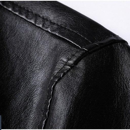 Close-up of black leather material with detailed stitching on a jacket or bag