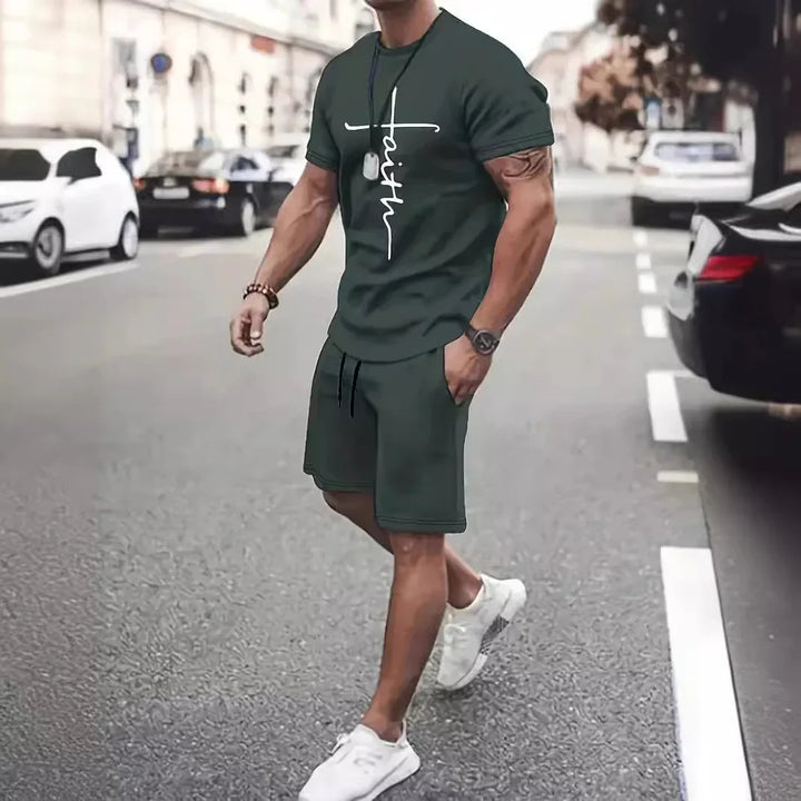 Man walking on street wearing dark green faith graphic t-shirt and shorts with white sneakers