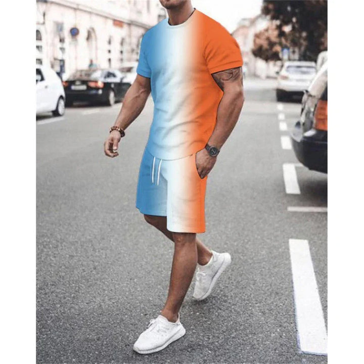 Man walking on street wearing vibrant half blue, half orange casual t-shirt and shorts with white sneakers