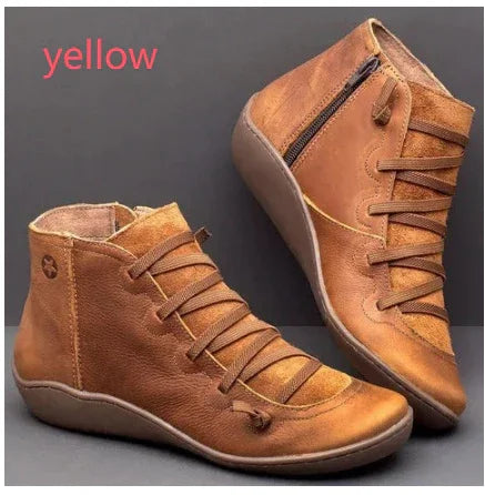 stylish brown leather ankle boots with side zipper and laces on gray background