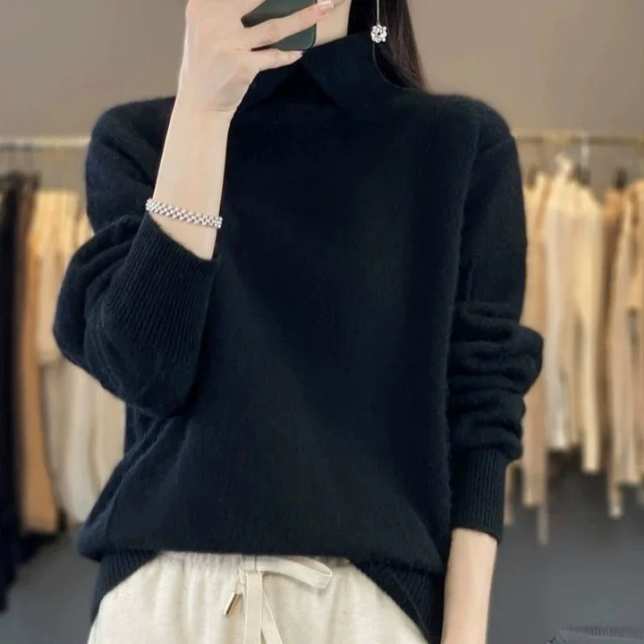 Woman wearing black turtleneck sweater with silver bracelet and flower earring, beige pants in boutique