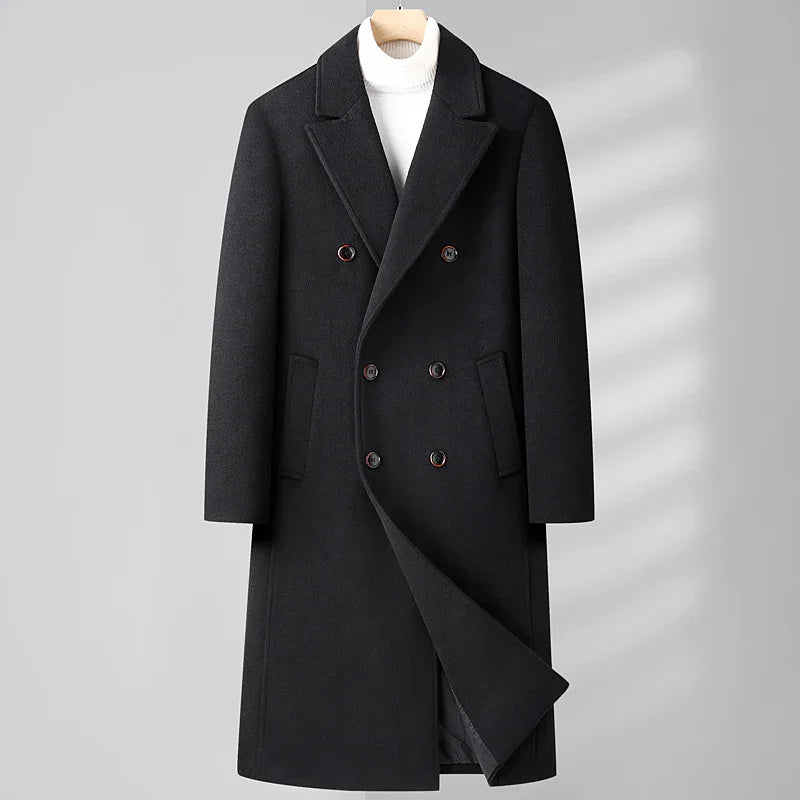Black double-breasted wool coat with lapel collar on hanger over white turtleneck sweater