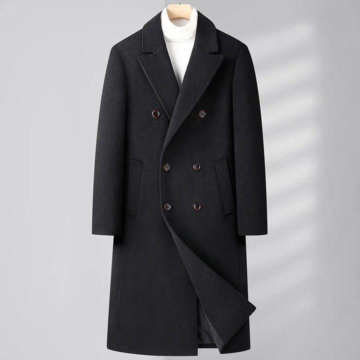 Black double-breasted wool coat with lapel collar on hanger over white turtleneck sweater