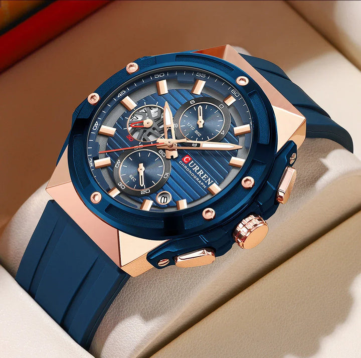Close-up of blue and rose gold Curren chronograph wristwatch with blue silicone strap