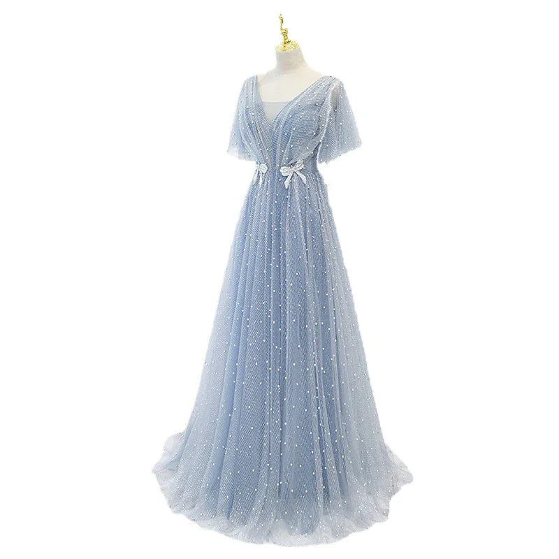 Elegant light blue evening gown with short sleeves, V-neck, pearl embellishments, and bow details