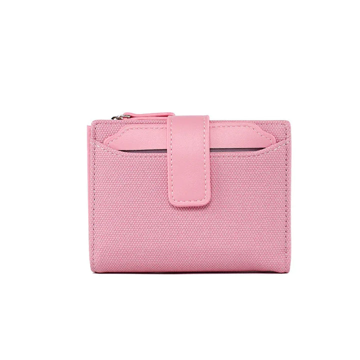 Compact pink canvas wallet with leather strap and zipper pocket on white background