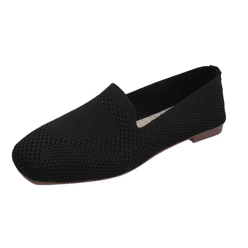 Black knitted slip-on flat shoe with textured upper and low brown sole