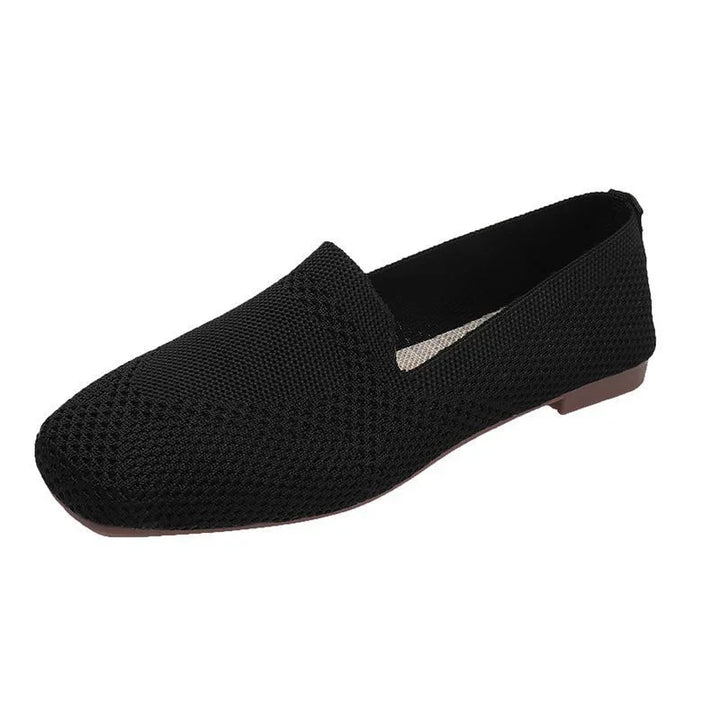 Black knitted slip-on flat shoe with textured upper and low brown sole