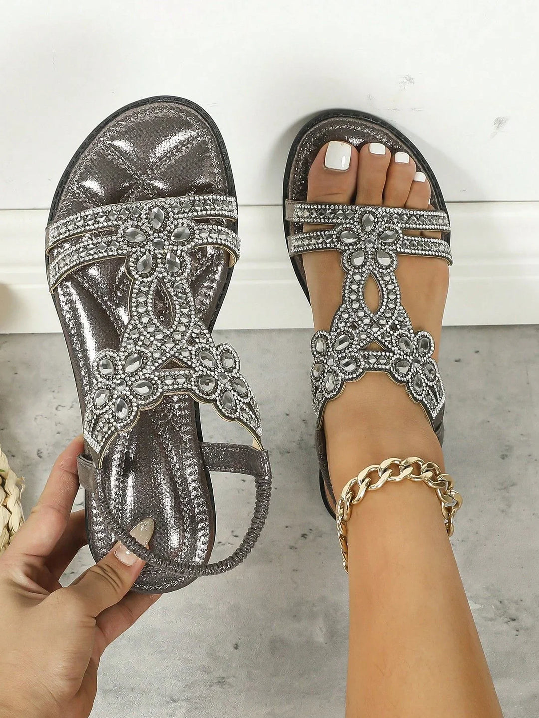 Women's metallic silver sandals with rhinestone flower embellishments and elastic ankle strap