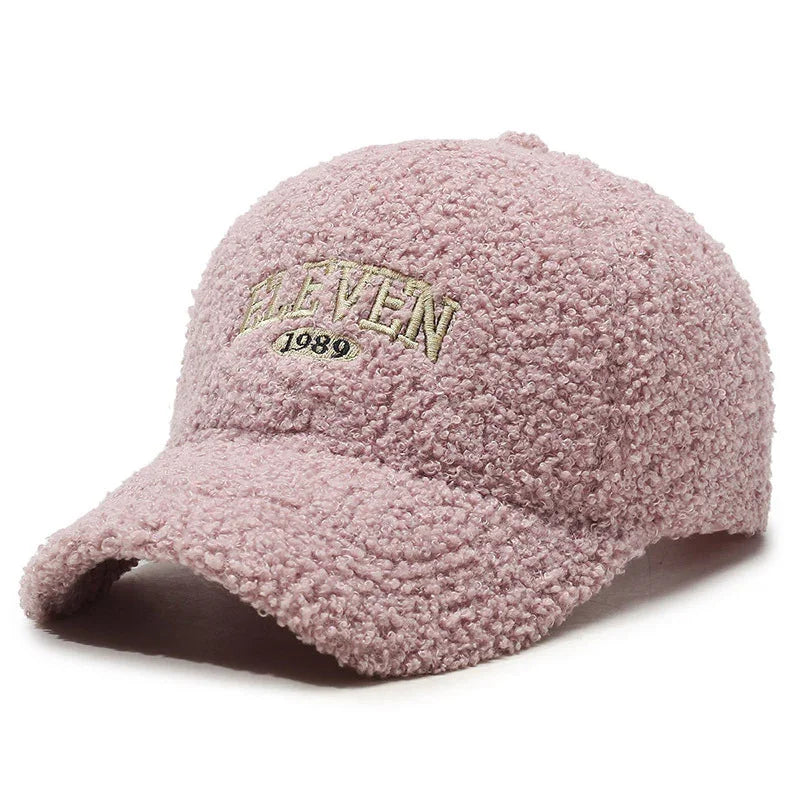 Pink textured fleece baseball cap with embroidered 'ELEVEN 1989' text on front