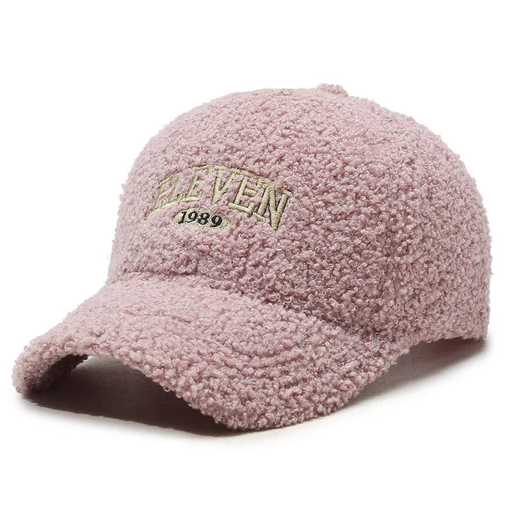Pink textured fleece baseball cap with embroidered 'ELEVEN 1989' text on front