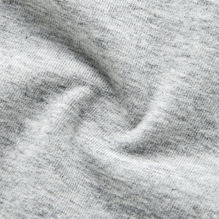 Close-up of soft heather gray cotton fabric with visible knit texture and subtle folds