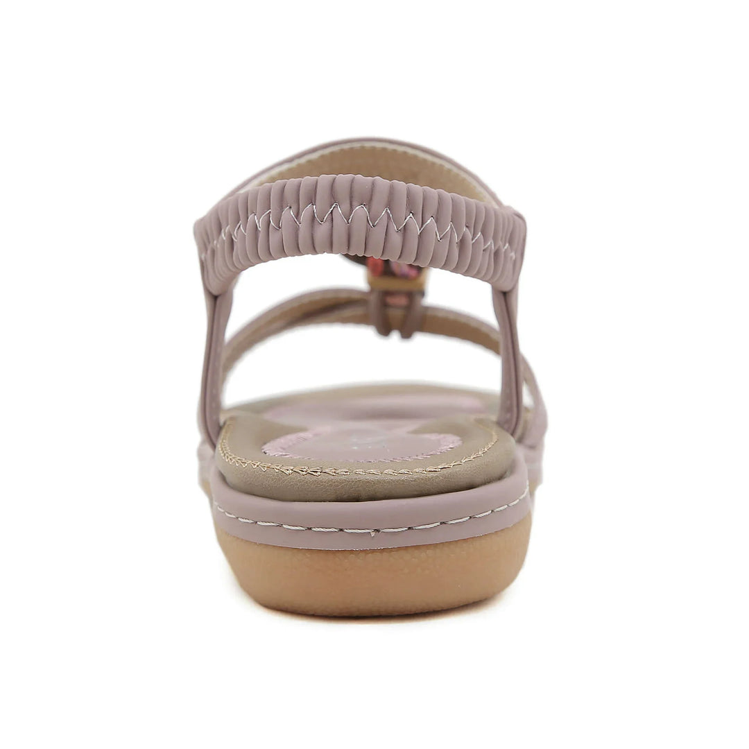 Rear view of taupe women's leather sandal with elastic strap and cushioned sole