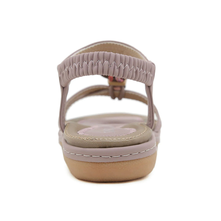 Rear view of taupe women's leather sandal with elastic strap and cushioned sole
