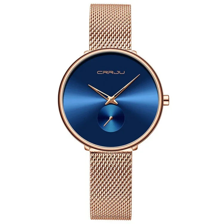 Elegant rose gold mesh band wristwatch with deep blue dial and minimalist design