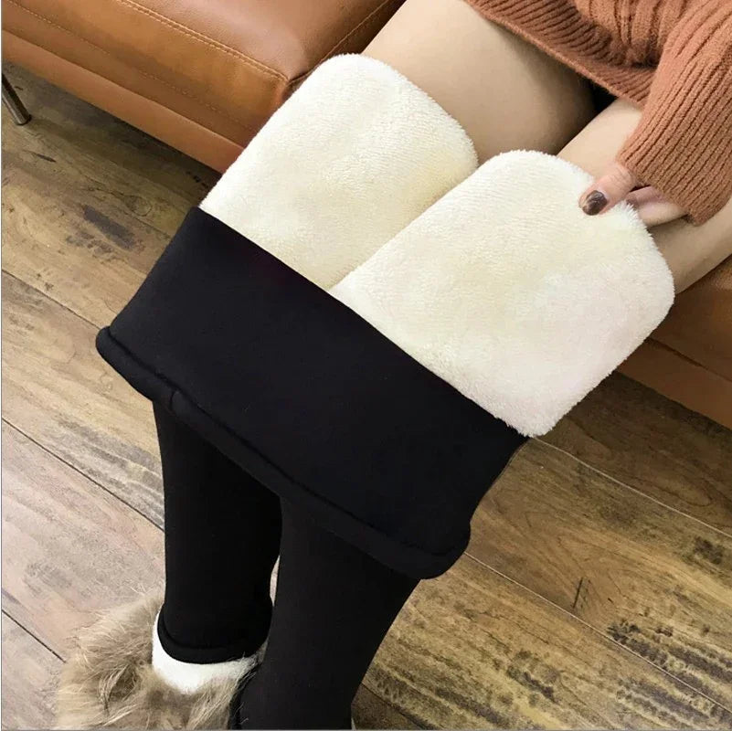 Black fleece-lined leggings with thick white plush inner layer, worn with furry boots on wooden floor