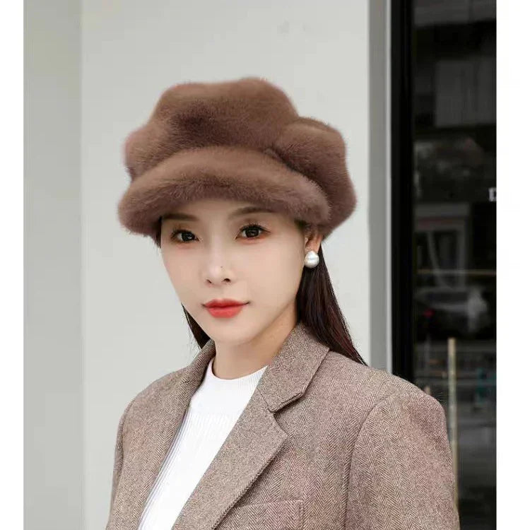 woman wearing brown faux fur beret hat, pearl earrings, and brown tweed blazer in urban setting